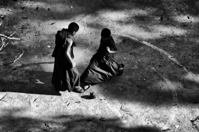 BUDDHIST MONKS PLAYING FOOTBALL by Jagdev Singh